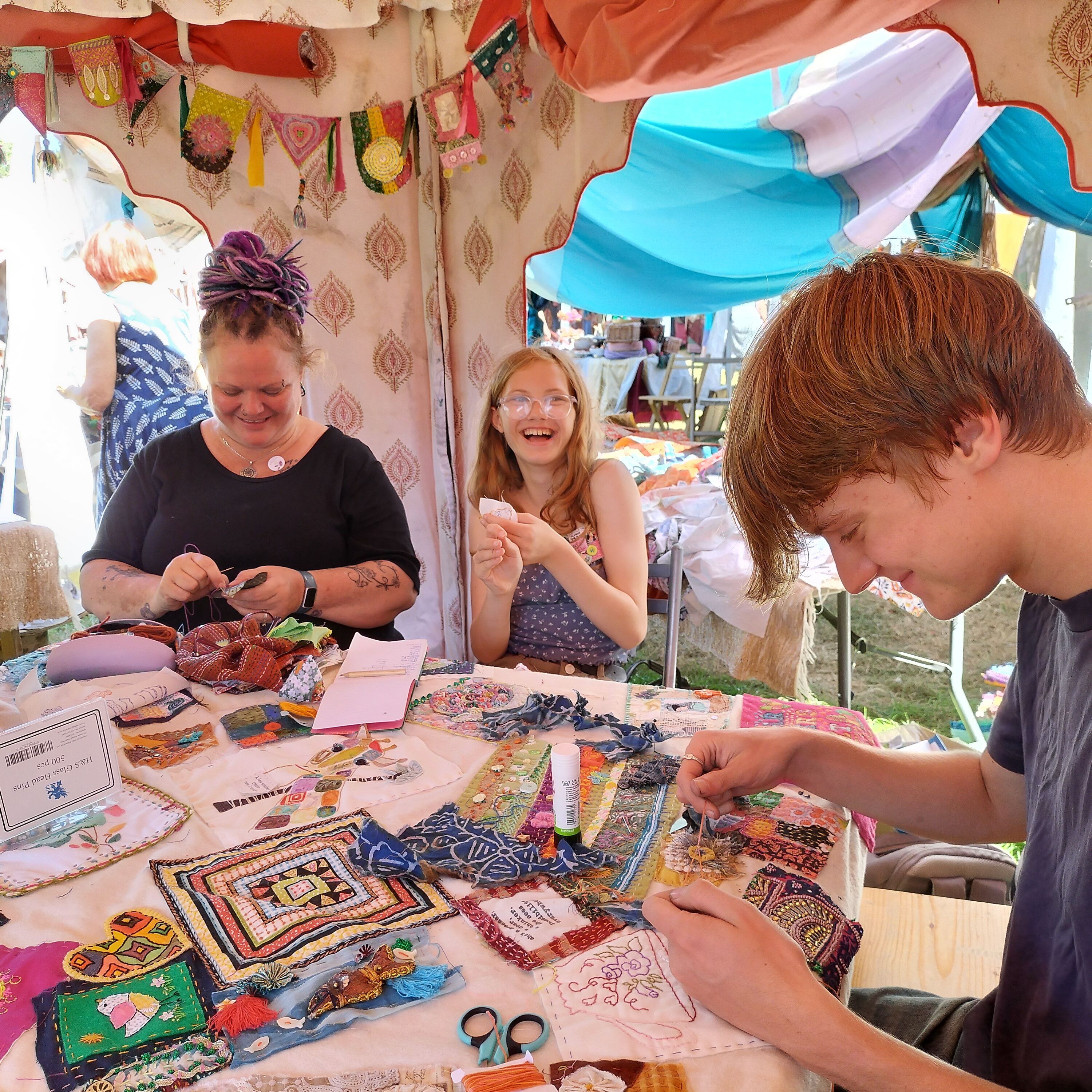 Community members working together on the quilt
