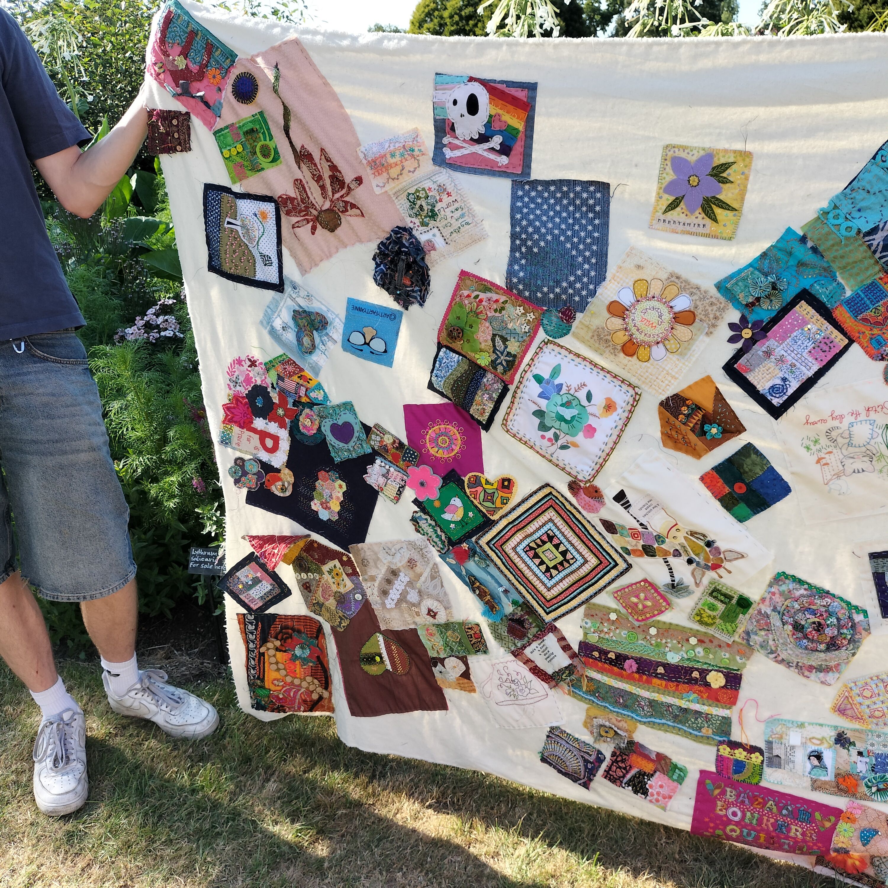 Close-up of colourful patches stitched onto a neutral background