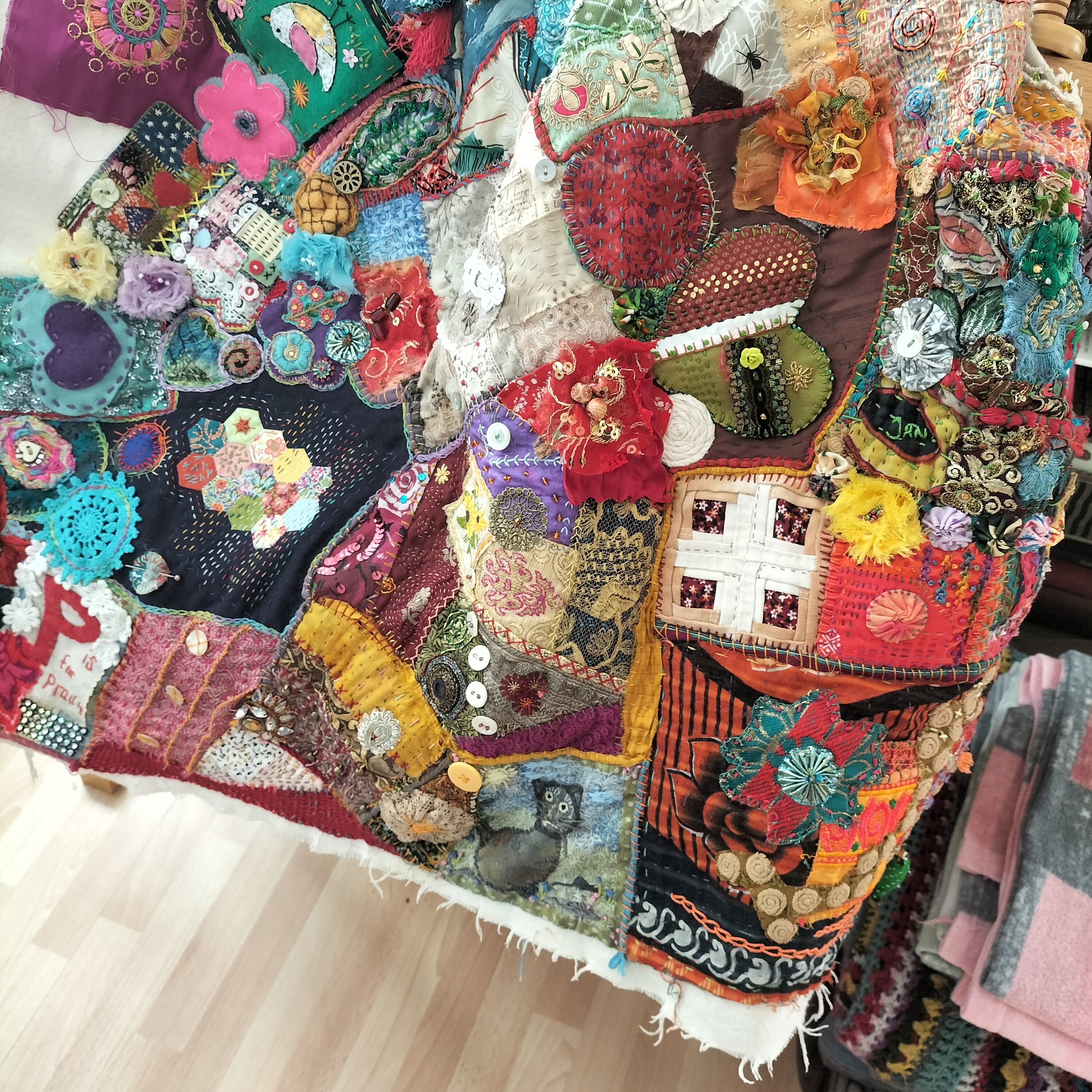 Part of a patchwork quilt draped over a frame